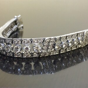 Puede incluir: Una pulsera de plata con una fila de diamantes redondos y una fila de diamantes cuadrados m&aacute;s peque&ntilde;os.