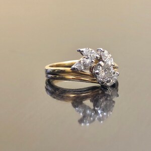 May include: A gold and white diamond engagement ring with a cluster of diamonds set in a leaf design.