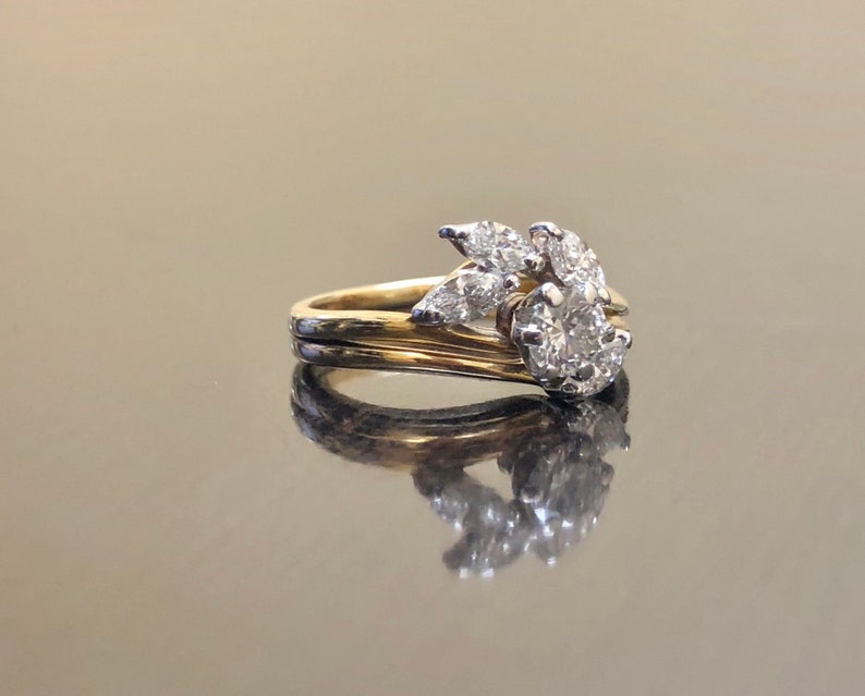 May include: A gold and white diamond engagement ring with a cluster of diamonds set in a leaf design.