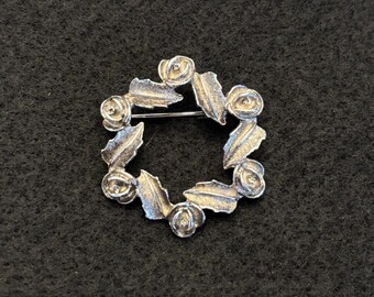 Broche vintage "Sarah Coventry" con forma de corona de rosas en tono plateado - década de 1970