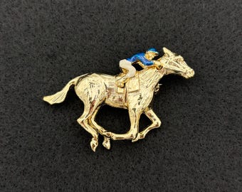 Pin de caballo jockey articulado vintage de "Gerry's" en tono dorado.