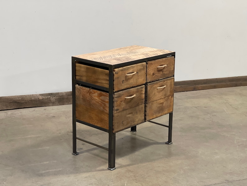 May include: A six-drawer wooden cabinet with a black metal frame and legs. The drawers are made of reclaimed wood and have rope handles.