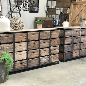 May include: Two large wooden storage cabinets with metal frames and multiple drawers. The cabinets are made of reclaimed wood and have a rustic look.