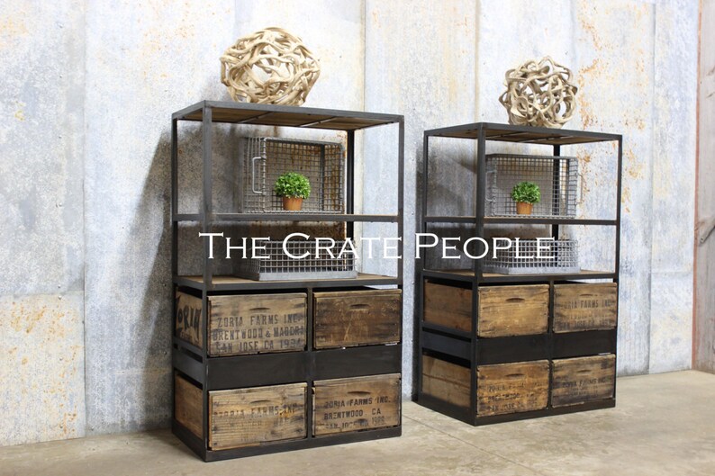 May include: Two black metal industrial shelving units with wooden crates and wire baskets. The shelves are stacked with crates and baskets, and there are decorative items on the top shelves. The text "THE CRATE PEOPLE" is visible in the center of the image.