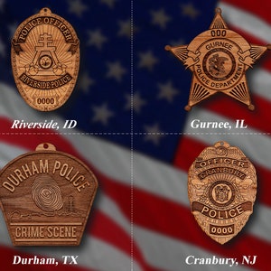 May include: Four wooden police badges with different designs and city names. The badges are on a red, white, and blue background. The badges are for Riverside, ID, Gurnee, IL, Durham, TX, and Cranbury, NJ.
