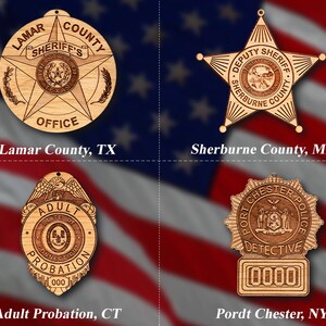May include: Four wooden ornaments featuring law enforcement badges. The top left ornament is a round badge with the text "Lamar County Sheriff's Office". The top right ornament is a star-shaped badge with the text "Deputy Sheriff Sherburne County". The bottom left ornament is a shield-shaped badge with the text "Adult Probation". The bottom right ornament is a round badge with the text "Port Chester Police Detective".