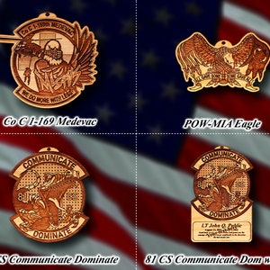 May include: Four wooden ornaments with different designs. The top left ornament features a helicopter and an eagle with the text "Co C 1-169th MEDEVAC WE DO MORE WITH LESS". The top right ornament features an eagle with the text "ALL GAVE SOME SOME GAVE ALL". The bottom left ornament features an eagle with the text "COMMUNICATE 81 CS DOMINATE". The bottom right ornament features an eagle with the text "COMMUNICATE DOMINATE LT John Q. Public 81 CS".