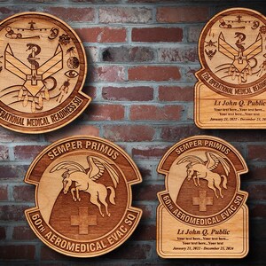 May include: Wooden plaques with engraved military emblems. Two round plaques feature the text "720 OPERATIONAL MEDICAL READINESS SQ" and a medical symbol. Two other plaques have a winged horse and the text "60TH AEROMEDICAL EVAC SQ".