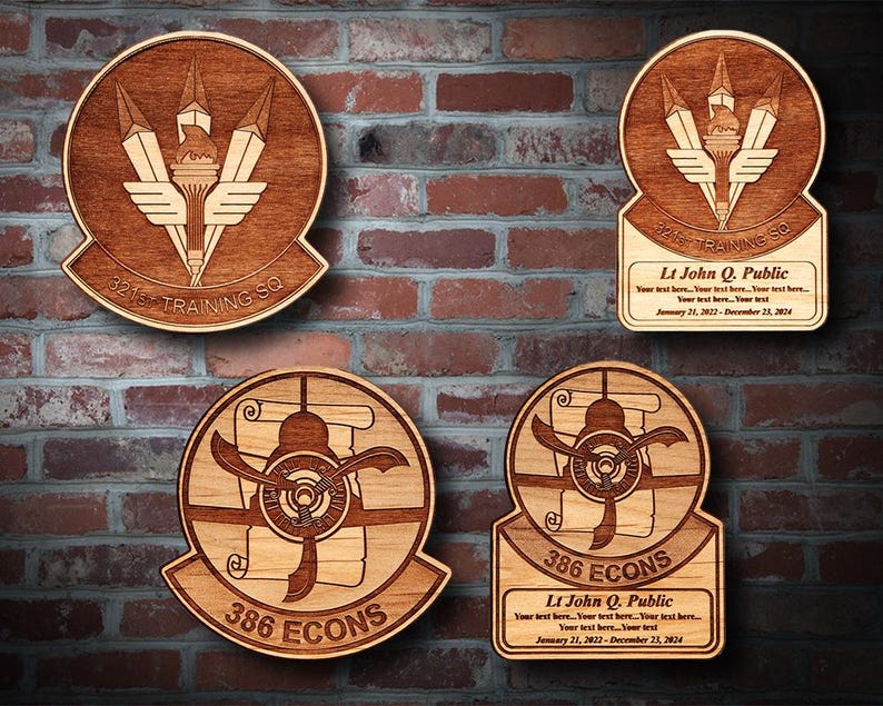 May include: Four wooden plaques with engraved designs and text. The top left plaque features a torch with wings and the text "321st Training Sq". The top right plaque features a similar design with the text "3245 Training Sq". The bottom left plaque features a propeller plane with the text "386 ECONS". The bottom right plaque features a similar design with the text "386 ECONS".