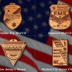 May include: Four wooden plaques with different designs. The top left plaque is brown and features the text "TRINITAS Regional Medical Center" with a star and a medical symbol. The top right plaque is brown and features the text "Somerset Medical Center EMS EST. 1982" with a medical symbol and a star. The bottom left plaque is brown and features the text "New Jersey's MONOC INTEGRITY PROFESSIONALISM EXCELLENCE". The bottom right plaque is brown and features the text "MEDICAL CENTER EMERGENCY MEDICAL SERVICES JERSEY CITY N.J. MC=." with a medical symbol and a star.