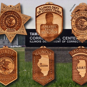 May include: Six wooden plaques with the text "Illinois Department of Corrections" and various other text. The plaques are decorated with a star, a state seal, and an outline of the state of Illinois.