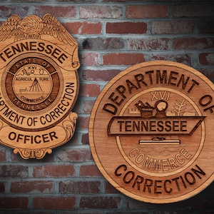 May include: Two wooden plaques with the text "Department of Correction" and the state seal of Tennessee. The top plaque has the words "State of Tennessee" and "Officer" on it. The bottom plaque has the Roman numeral XVI and the words "Commerce" and "Tennessee".