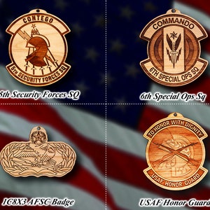 May include: Four wooden ornaments featuring different military unit insignia. The top left ornament features a lightning bolt, a helmet, and the text "CONTEGO 5TH SECURITY FORCES SQ". The top right ornament features a sword, a star, and the text "COMMANDO 6TH SPECIAL OPS SQ". The bottom left ornament features a bird with wings spread and the text "1C8X3 AFSC Badge". The bottom right ornament features crossed rifles, a helmet, and the text "TO HONOR WITH DIGNITY USAF HONOR GUARD".