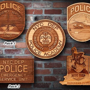 May include: Five wooden plaques with different designs and text. The plaques are all brown and have a wood grain texture. The text on the plaques includes "NYC DEP POLICE", "EMERGENCY SERVICE UNIT", "HONOR INTEGRITY COURAGE", "POLICE AVIATION", and "RUNNERS CLUB".