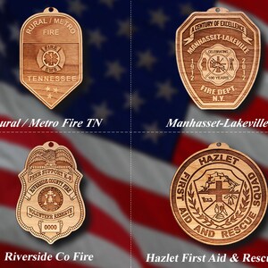 May include: Four wooden plaques with different designs. The top left plaque is brown and features the text "Rural/Metro Fire" and "Tennessee". The top right plaque is brown and features the text "Manhasset-Lakeville Fire Dept. N.Y.". The bottom left plaque is brown and features the text "Peer Support K-9 Riverside County Fire Volunteer Reserve". The bottom right plaque is brown and features the text "Hazlet First Aid and Rescue Squad".
