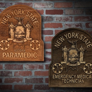 May include: Two wooden plaques with the New York State seal and the words "New York State" and "Paramedic" or "Emergency Medical Technician".