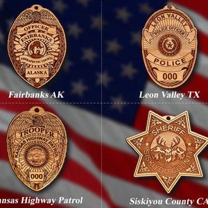 May include: Four wooden ornaments shaped like police badges and a sheriff's star. The ornaments are all brown and feature the names of the law enforcement agencies they represent: Fairbanks AK, Leon Valley TX, Kansas Highway Patrol, and Siskiyou County CA.
