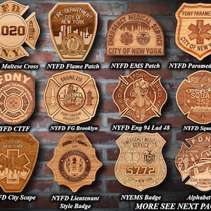 May include: A collection of wooden plaques featuring various New York City Fire Department (FDNY) and Emergency Medical Service (EMS) patches. The patches are intricately carved with details such as the FDNY logo, the city's skyline, and the words "FDNY" and "EMS".