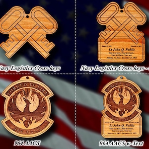 May include: Four wooden ornaments with a patriotic theme. Two feature crossed keys, labeled "Navy Logistics Cross keys." The other two display a phoenix design with the text "964 AACS" and "Forged in Fire." Two ornaments include personalized text.