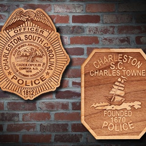 May include: Two wooden plaques with engraved designs. The first plaque is a police badge with an eagle, the text "Charleston, South Carolina", and the year "1812". The second plaque is octagonal with a ship, the text "Charleston S.C. Charles Towne", and the year "1670".