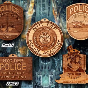 May include: Five wooden ornaments featuring different designs related to the New York City Police Department. The ornaments feature the words "Police", "NYC DEP", "Emergency Service Unit", "Aviation", and "Runners Club".