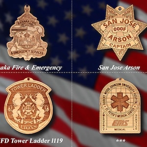May include: Four wooden ornaments featuring different designs. The top left ornament is a brown and gold shield with the text "Kanaka Fire & Emergency Services". The top right ornament is a brown star with the text "San Jose 000F Arson Captain". The bottom left ornament is a brown shield with the text "Tower Ladder FD XL119 NY Lions". The bottom right ornament is a brown shield with the text "Robert Wood Johnson University Hospital St. Peter's Medical Center Emergency EMS Medical Service".