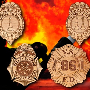 May include: Wooden firefighter badges with engraved text. The badges include "LIEUTENANT", "CAPTAIN", and "CHIEF" titles, along with "ENGINE CO. NO. 2", "VALLEY STREAM", and "F.D." The fourth badge has "V.S. 86 F.D." engraved.