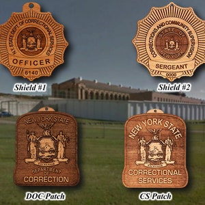 May include: Four wooden plaques with engraved images and text. The top two plaques are star-shaped and feature the text "N.Y. STATE DEPT. OF CORRECTIONAL SERVICES" and "CORRECTIONS AND COMMUNITY SUPERVISION STATE OF NEW YORK". The bottom two plaques are rectangular and feature the text "NEW YORK STATE" and the state seal of New York. The text "DEPARTMENT OF CORRECTION" and "CORRECTIONAL SERVICES" are also visible.