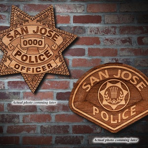 May include: Two wooden plaques with the words "San Jose Police" on them. The top plaque is a star shape with the words "Officer" below. The bottom plaque is a shield shape.