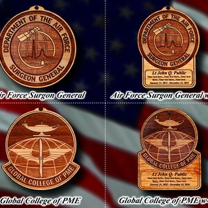May include: Four wooden ornaments with different designs. The top left ornament is a brown circle with the text "Department of the Air Force Surgeon General". The top right ornament is the same design with a small white rectangle with text. The bottom left ornament is a brown circle with the text "Global College of PME". The bottom right ornament is the same design with a small white rectangle with text.
