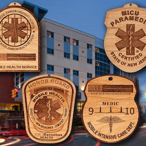 May include: Four wooden plaques with a medical theme. The top plaque is brown with the text "Robert Wood Johnson University Hospital" and "Robert Wood Johnson Health Network". The second plaque is brown with the text "MICU Paramedic" and "State of New Jersey Certified". The third plaque is brown with the text "Honor Guard Fortitudo Per Unitaten Mobile Health Jersey City I New Brunswick-Somerset I Rahway RWJ Barnabas Health". The fourth plaque is brown with the text "RWJ Robert Wood Johnson Health System Medic 9-10 Mobile Intensive Care Dept."