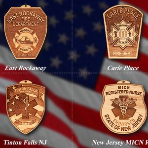 May include: Four wooden plaques with different designs. The top left plaque is for the East Rockaway Fire Department, the top right plaque is for the Carle Place Fire Department, the bottom left plaque is for the Tinton Falls EMS, and the bottom right plaque is for the New Jersey MICN Registered Nurse.