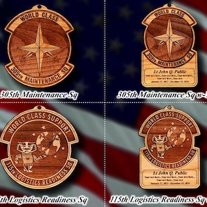 May include: Four wooden ornaments with a world class design. The top left ornament says "World Class 305th Maintenance Sq". The top right ornament says "World Class 305th Maintenance Sq" with additional text below. The bottom left ornament says "World Class Support 115th Logistics Readiness Sq". The bottom right ornament says "World Class Support 115th Logistics Readiness Sq" with additional text below.