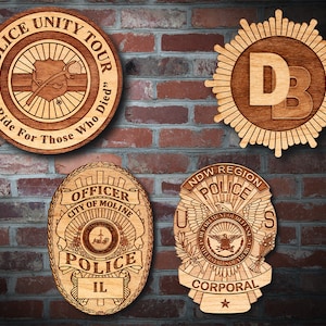 May include: Four wooden plaques with laser-engraved police badges. The top left plaque reads "Police Unity Tour" with a graphic of a fallen officer's badge. The top right plaque reads "DB" in a starburst design. The bottom left plaque reads "Officer City of Moline Police IL". The bottom right plaque reads "NDW Region Police US Corporal".