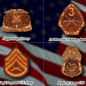 May include: Four wooden ornaments featuring military insignia. The top left ornament features a winged eagle with a wheel and the text "Supporting Victory". The top right ornament features a shield with the text "3rd Recruit Training Battalion" and the number "3". The bottom left ornament features a chevron with crossed rifles. The bottom right ornament features a shield with the text "Department of the Army CID Agent".