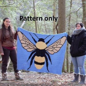 May include: A crochet pattern for a blue blanket with a large yellow and black bumblebee design. The pattern is called "Pattern only".