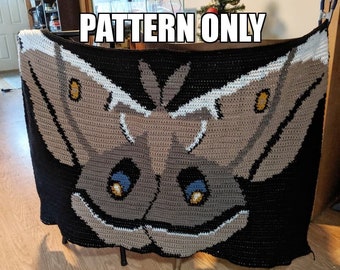 May include: A crochet blanket featuring a brown and white moth with blue eyes. The blanket is black with a white border. The text "PATTERN ONLY" is visible at the top of the image.