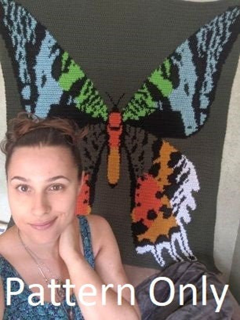 May include: A crochet pattern for a colorful butterfly blanket. The pattern is for a large butterfly with green, blue, orange, and black wings. The text "Pattern Only" is at the bottom of the image.