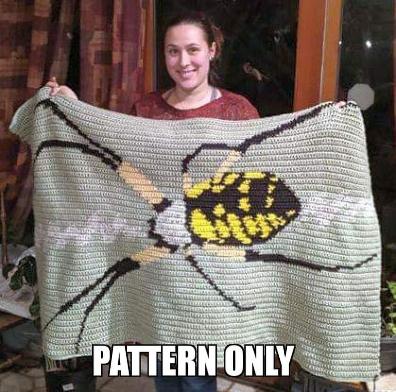 May include: A crochet pattern for a blanket featuring a yellow and black spider. The pattern is written "PATTERN ONLY".