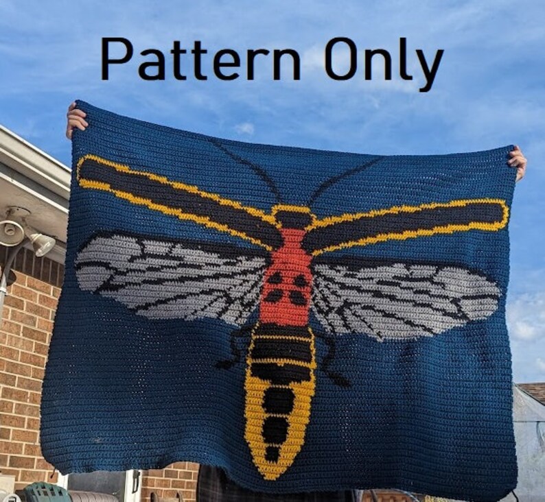 May include: A crochet blanket featuring a large, colorful insect with yellow, black, red, and gray details. The insect is centered on a dark blue background. The text "Pattern Only" is displayed at the top of the image.