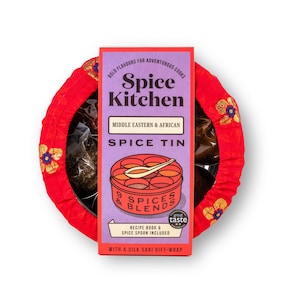 May include: A red and gold gift-wrapped box containing a Spice Kitchen Middle Eastern & African Spice Tin. The tin features a colourful illustration of a spice tin with the text "9 Spices & Blends" and "Taste Great". The box includes a recipe book and a spice spoon.