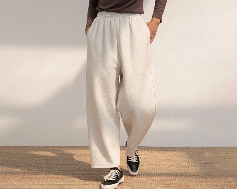 May include: White wide-leg pants with a relaxed fit and a drawstring waistband.