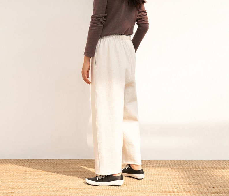 May include: A pair of white wide-leg pants with a drawstring waist.
