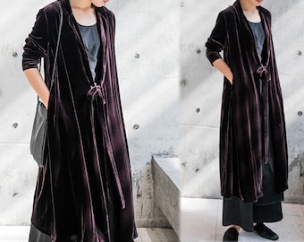 May include: A long, dark purple velvet robe with a tie at the waist. The robe has a deep V-neckline and long sleeves.