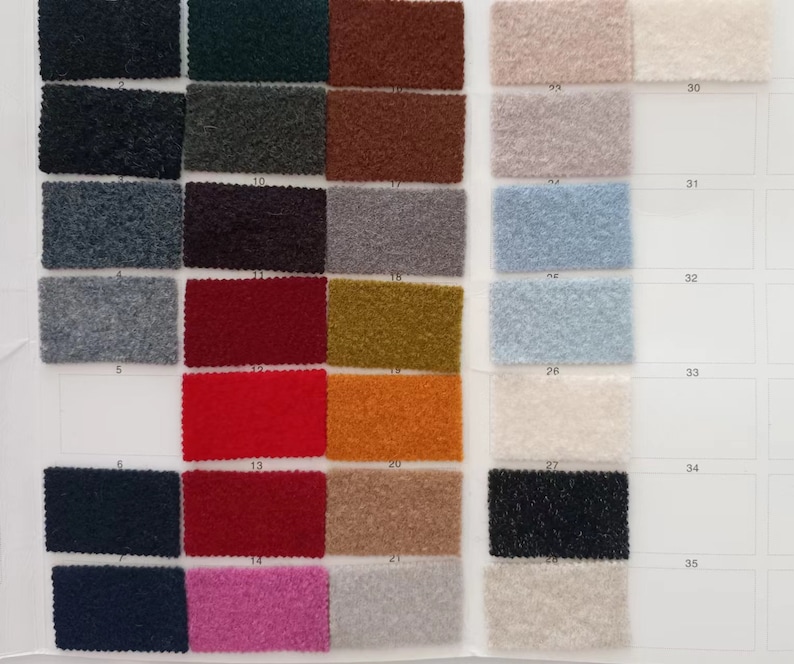 May include: A fabric swatch book featuring 35 different fabric samples. The samples are arranged in rows and columns, with each sample labelled with a number. The fabric samples are in a variety of colours, including black, white, grey, red, blue, green, brown, and orange.
