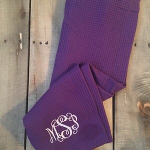 May include: Purple waffle weave bathrobe with white monogram "MSS".