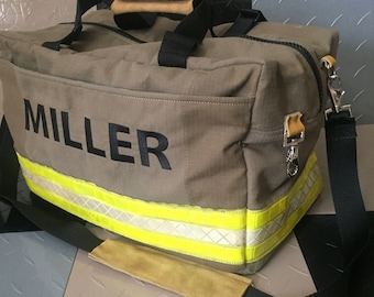 May include: A tan duffel bag with the name "MILLER" in black block letters. The bag has a black shoulder strap and handles with tan suede-like padding. The bottom of the bag features reflective yellow and silver stripes.