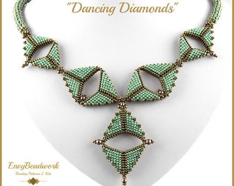 May include: A green and gold beaded necklace with a geometric design. The necklace is called "Dancing Diamonds".