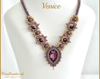 May include: A handcrafted necklace with a central, large, faceted purple gemstone. The necklace features smaller purple and gold-toned beads and accents, with the word "Venice" in gold script. The necklace is displayed on a white mannequin.