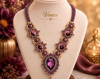 May include: A beaded necklace featuring a large, central, pear-shaped purple crystal surrounded by smaller purple and gold beads. The necklace includes symmetrical floral-like motifs with purple centers and gold petals, with the word Venice printed above.